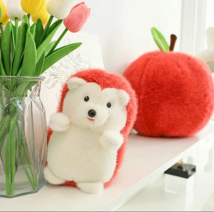 Close-up of the Apple Hedgehog Plush Pillow, showing the hedgehog plush separately, with a vase of colorful tulips in the background