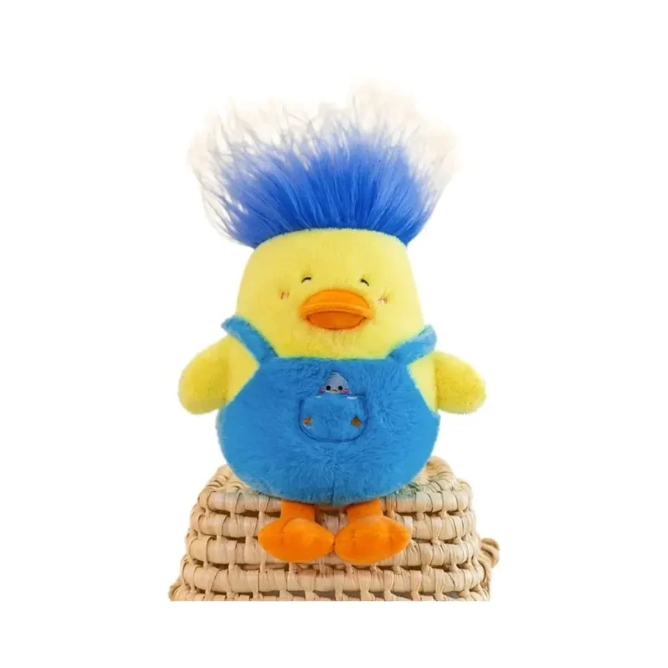 A cute duck plush toy wearing blue overalls with spiky blue hair, sitting on a woven basket against a white background