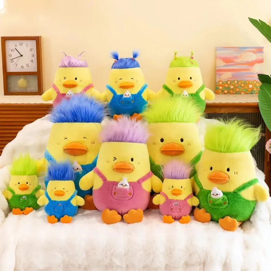 A collection of nine duck plush toys in different sizes, colors, and fun hairstyles, arranged on a cozy white blanket
