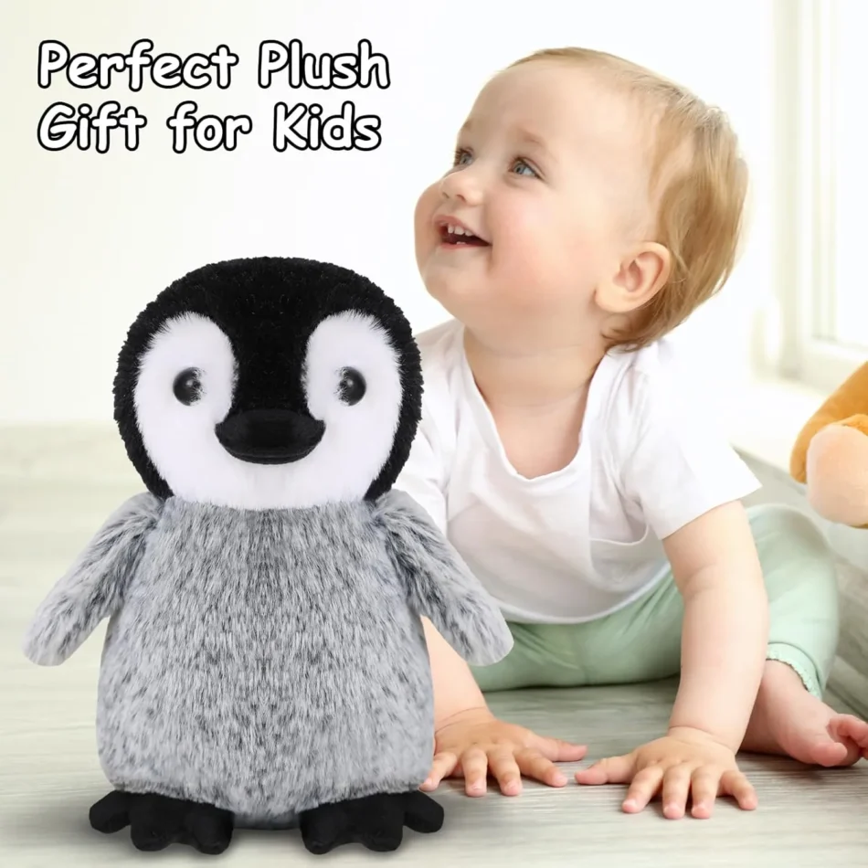 Cute baby playing with a soft and cuddly penguin plush toy, the perfect gift for kids