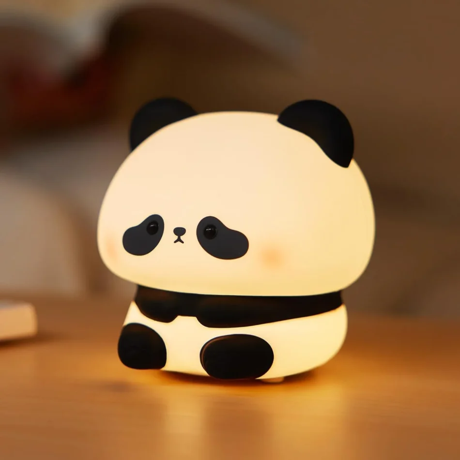 Close-up of cute panda night lamp on wooden table
